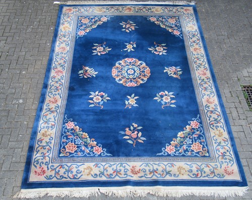 Lot 641 - A Chinese wool carpet, with floral sprigs, on...