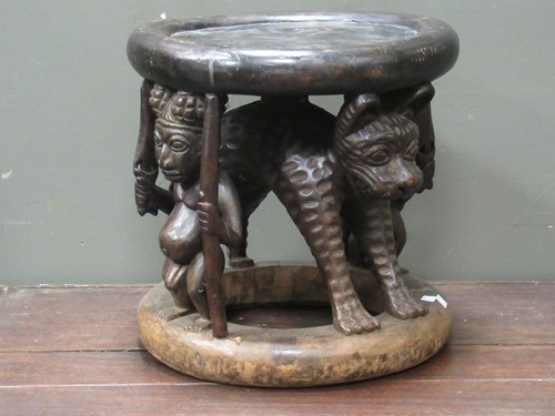 Lot 158 - A Bamileke circular stool, with carved leopard...