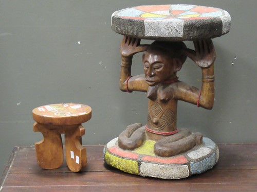 Lot 160 - An African circular stool with beaded...