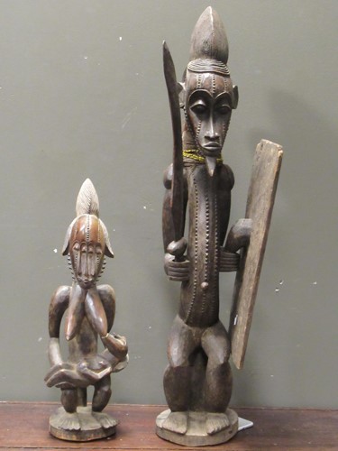 Lot 172 - A Senufo carved wood warrior figure standing...