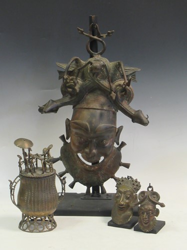 Lot 125 - A Bamileke bronze mask surmounted by scrolling...