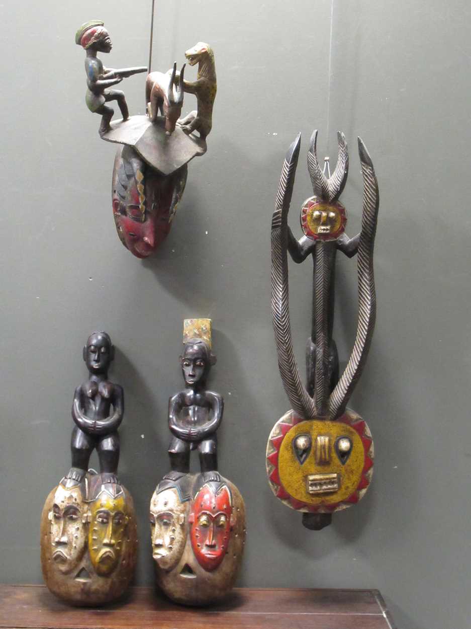 Lot 162 - A Guro mask with a red painted feminine face...