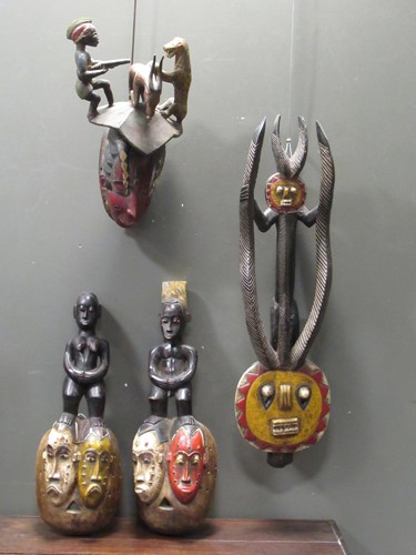 Lot 162 - A Guro mask with a red painted feminine face...