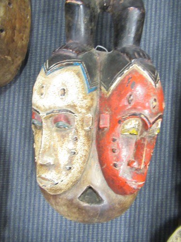 Lot 162 - A Guro mask with a red painted feminine face...