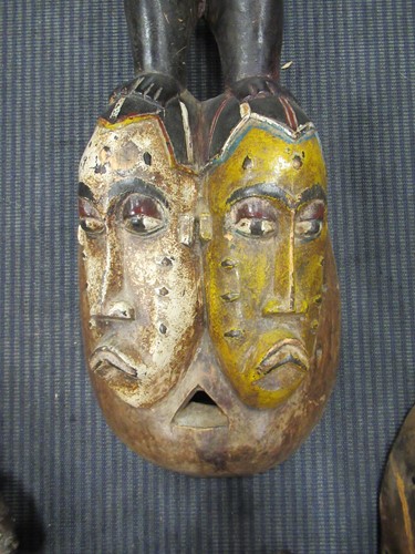 Lot 162 - A Guro mask with a red painted feminine face...