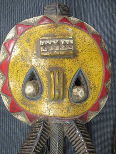 Lot 162 - A Guro mask with a red painted feminine face...