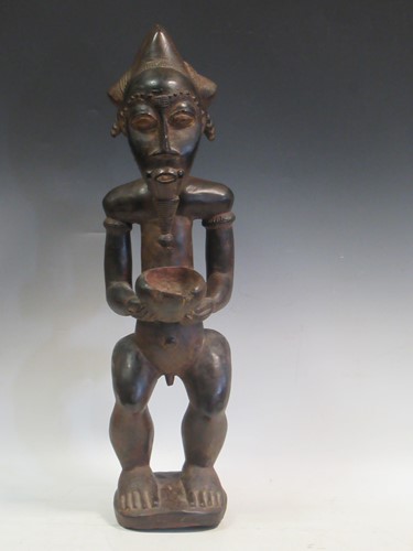 Lot 177 - A carved tribal figure of a man, 53cm high