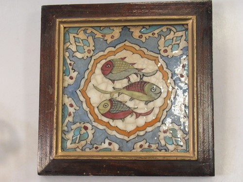 Lot 114 - A Persian tile decorated with three fish, 19.5...