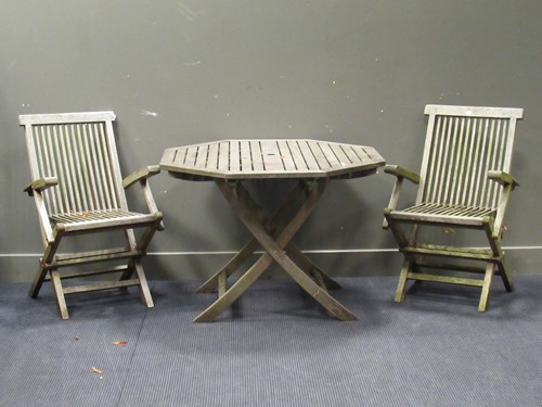 Lot 630 - A modern teak octagonal folding garden table...