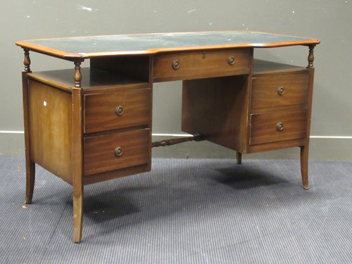 Lot 528 - A 20th century curved writing desk with green...