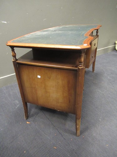 Lot 528 - A 20th century curved writing desk with green...