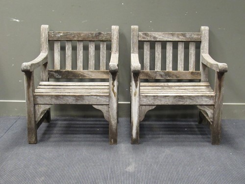 Lot 627 - A pair of hardwood garden armchairs