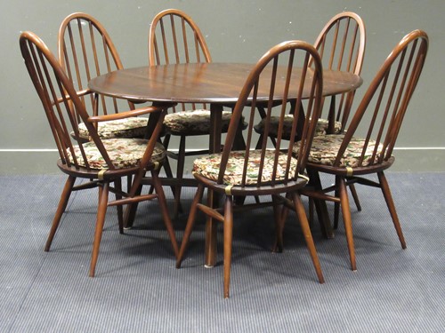 Lot 556 - An Ercol Model 377 dark stained beech and elm...