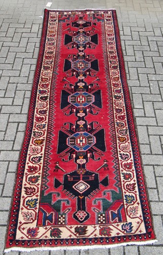 Lot 563 - A red ground Hamadan runner 300 x 102cm, modern
