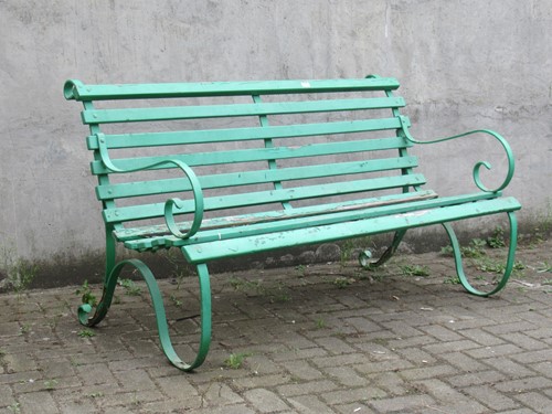 Lot 632 - A green painted garden bench with wooden slats...