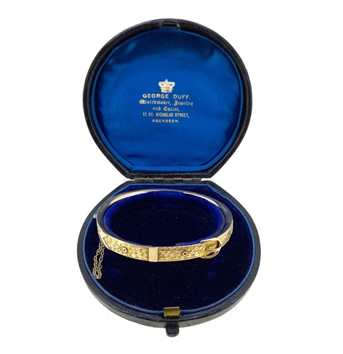 Lot 116 - A late Victorian buckle style hinged bangle