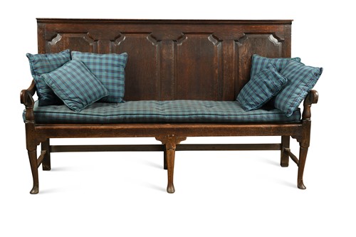 Lot 715 - An early George III oak settle