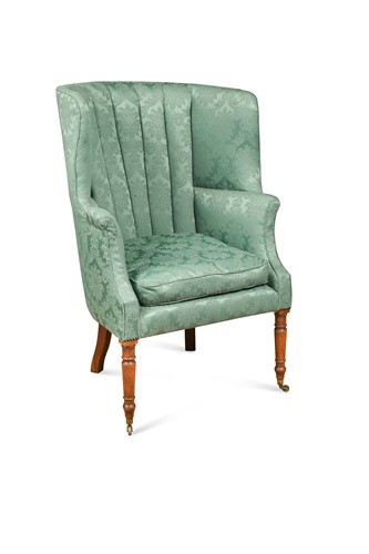 Lot 769 - A George III barrel back wing armchair