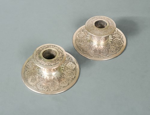 Lot 356 - A 20th century Iranian metalwares vase together with a pair of dwarf candlesticks
