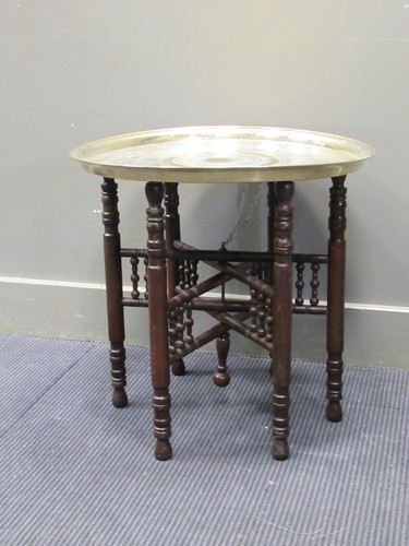 Lot 484 - A Benares type brass tray on folding stand 55...