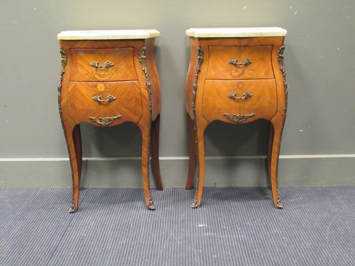 Lot 475 - A pair of French marble topped bombé bedsides...