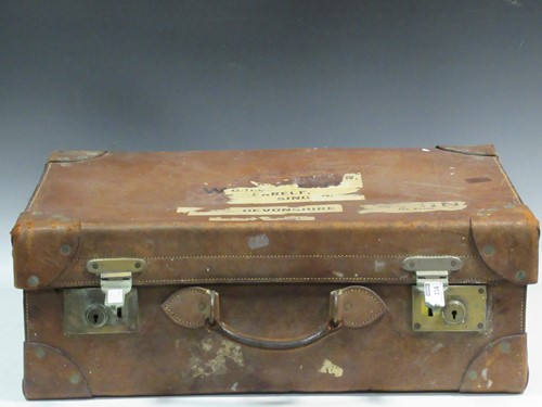 Lot 234 - A leather suitcase containing five silver...