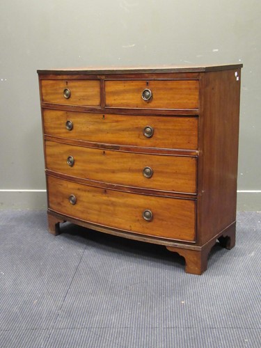 Lot 391 - A Regency mahogany bow front chest of two...