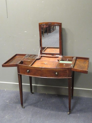 Lot 532 - A George III mahogany bow front dressing table,...