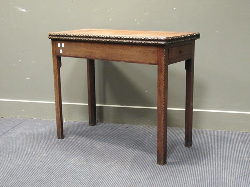 Lot 523 - A George III mahogany fold over tea table with...