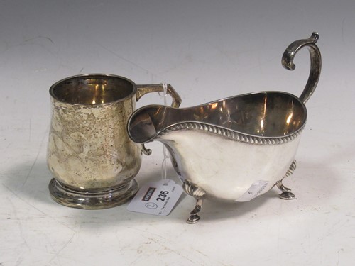 Lot 235 - A silver sauce boat together with a small...