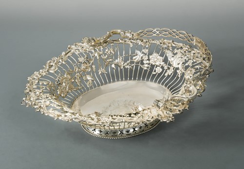 Lot 366 - A George III silver swing handled cake basket