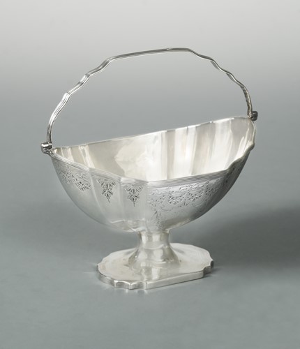 Lot 379 - A George III 18th century silver swing handled sugar basket