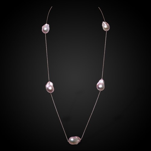 Lot 177 - A rose coloured chain with scattered freshwater cultured baroque pearls