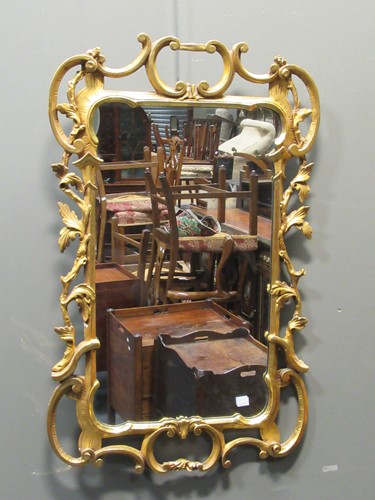 Lot 496 - A Rococo style gilt rectangular wall mirror...