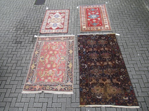 Lot 554 - A dark blue ground geometric rug together with...