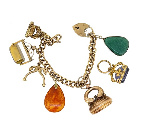 Lot 46 - A late 20th century charm bracelet with assorted charms