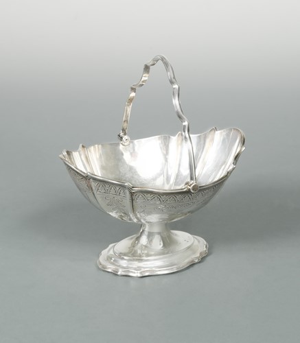 Lot 445 - An Edward VII silver swing handled sugar basket