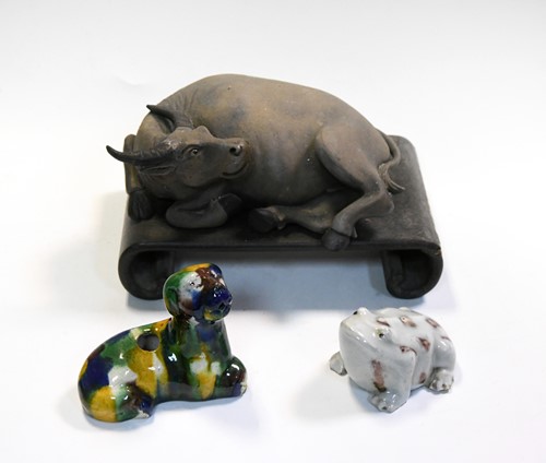 Lot 52 - A Chinese Yixing -Style Stoneware figure of a recumbent water buffalo, 19/20th century