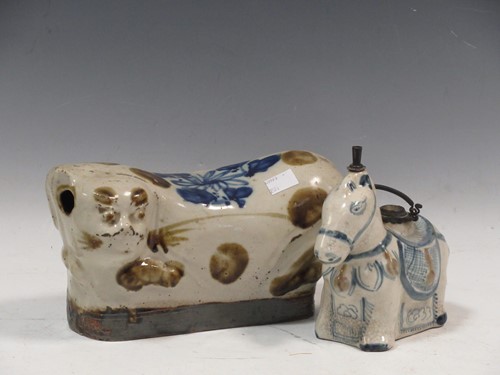 Lot 1 - A Chinese provincial stoneware pillow as a cat, late Qing Dynasty/Republic, 24cm long