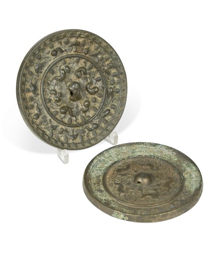 Lot 57 - A Chinese bronze Lion and Grapevine mirror, probably Tang Dynasty