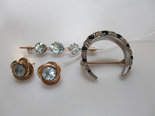 Lot 310 - A blue stone brooch stamped '9CT', a blue...