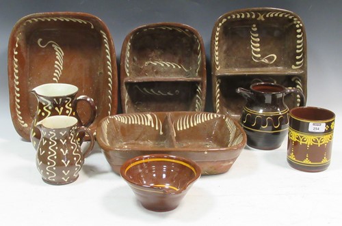 Lot 254 - A collection of slipware, including cooking...