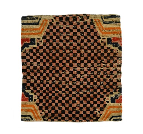 Lot 387 - A Tibetan sitting rug, late 19th century