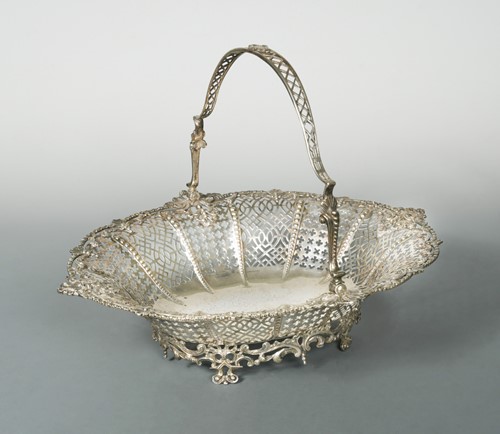 Lot 373 - An early George III 18th century silver swing handled cake basket