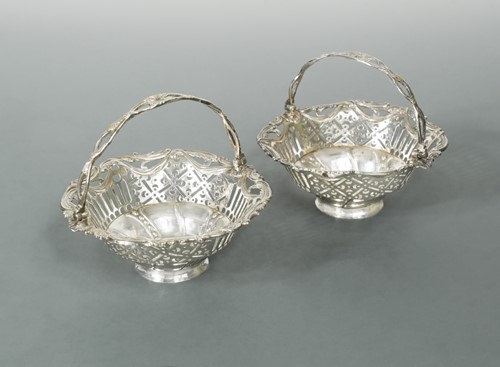 Lot 504 - Dublin - A pair of (possibly) George III silver swing handled bon bon dishes