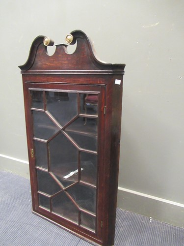 Lot 576 - A George III glazed oak corner cupboard with...