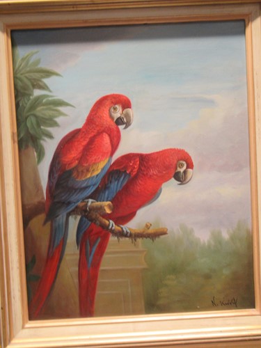 Lot 460 - An oil painting of two scarlet McCaw parrots....