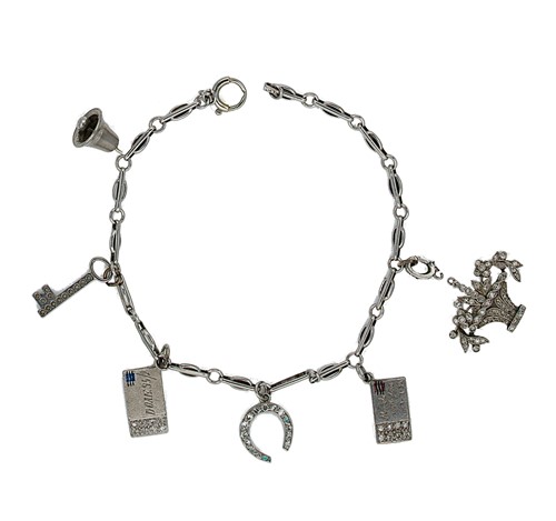 Lot 141 - A charm bracelet with diamond set charms