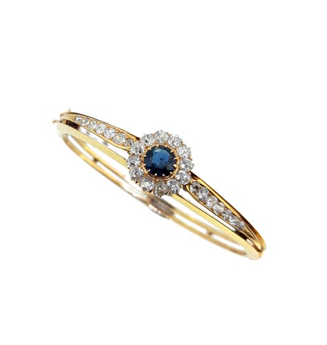 Lot 68 - A sapphire and diamond cluster style bangle