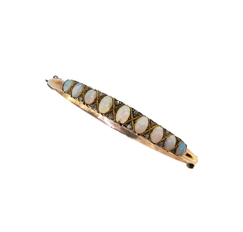 Lot 74 - An early 20th century opal and diamond bangle